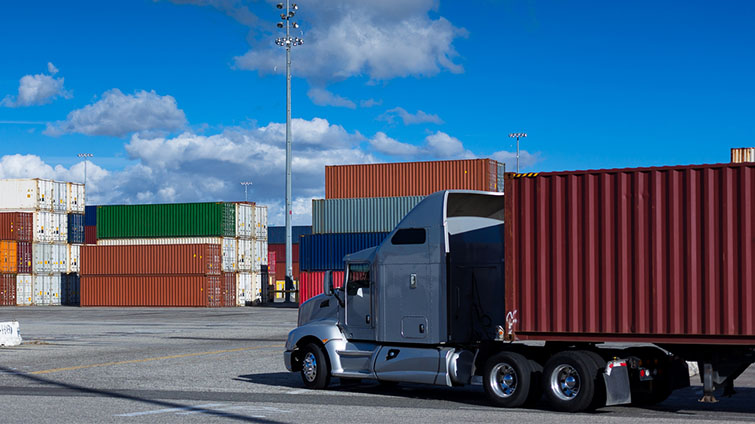 Drayage truck hauling shipping container